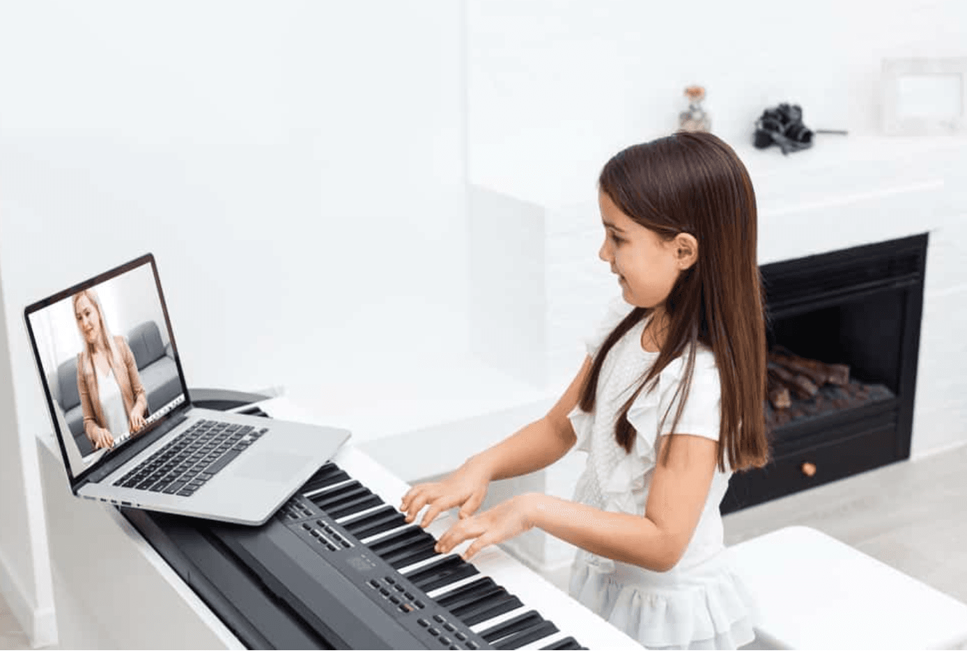 Student taking an online piano lesson at home